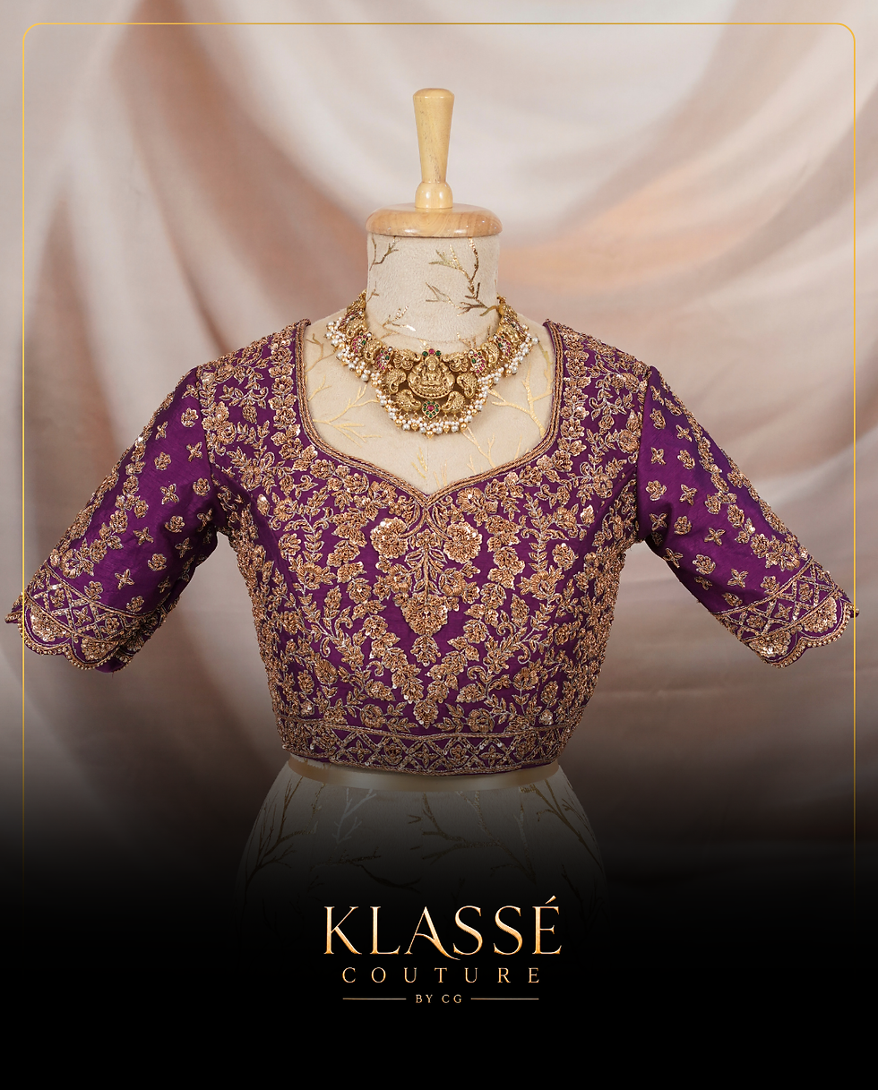 Deep purple blouse with intricate gold zari work and elbow-length sleeves.