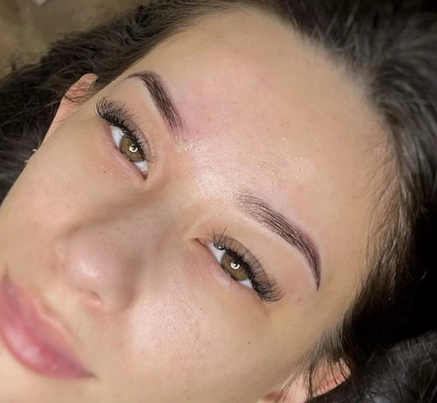 close-up woman with green eyes and dark lifted lashes