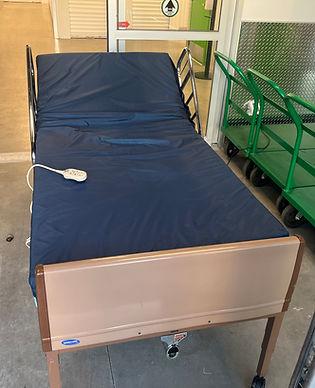Blue Invacare hospital bed mattress with frame and remote control