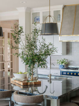Custom metal range hood with brass accents in the woodlands, texas