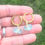 Thumbnail: gold huggie hoop sea glass earrings on hand