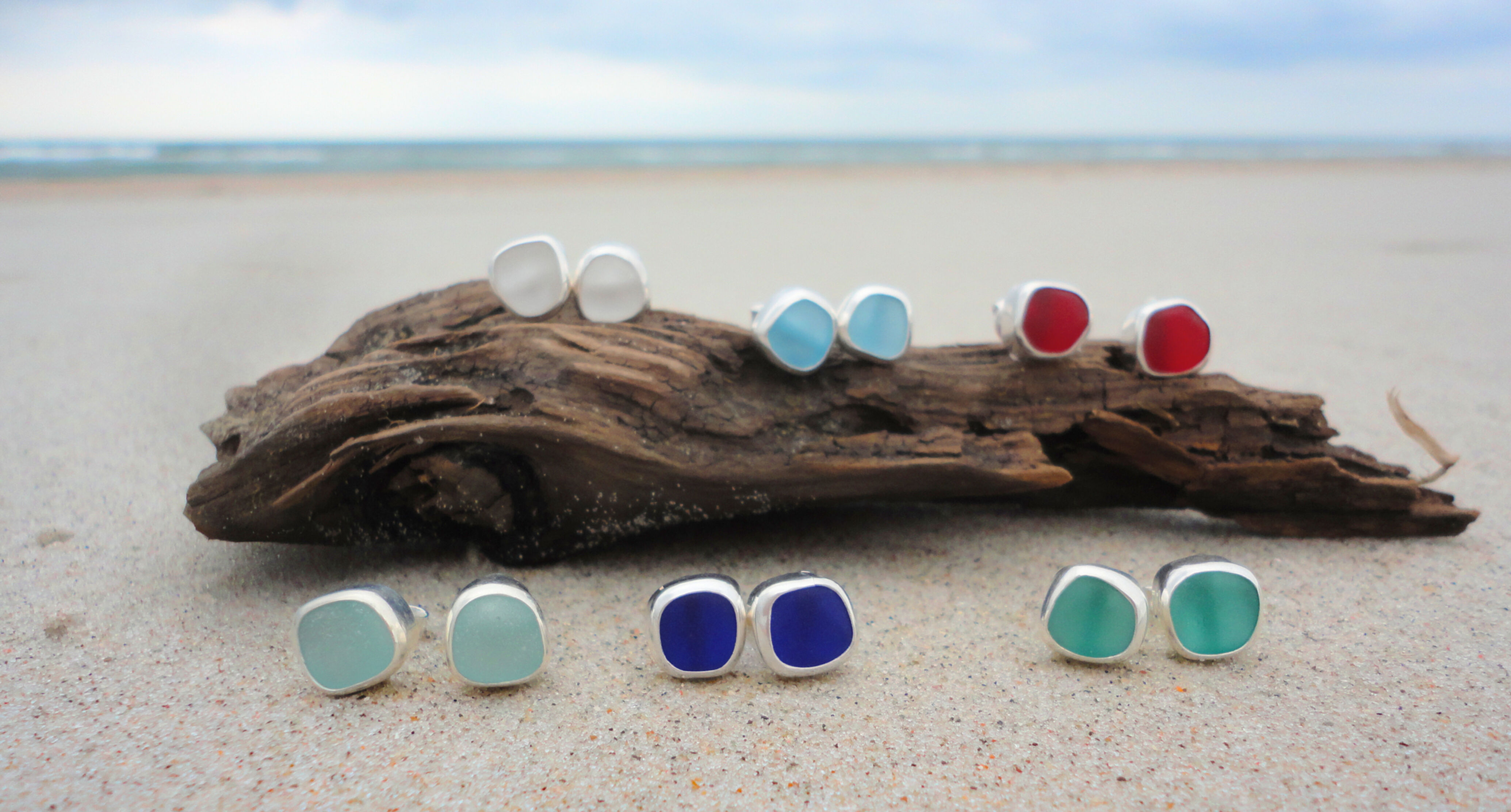 sea glass studs in row on beach
