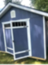Blue shed with white trim, double doors, and windows