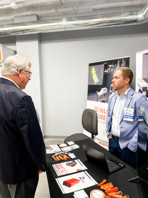 Ryan Lilly (R), discusses Senswork products at their display booth.