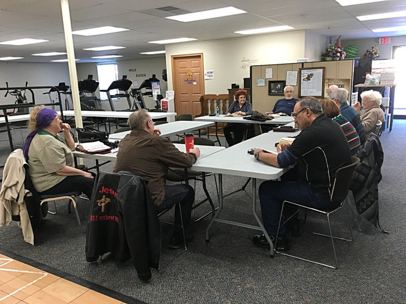 Group of adults meeting around tables