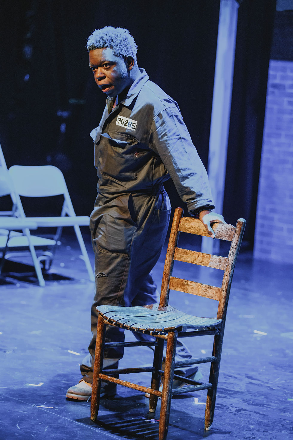 Senior Prince Miller plays Red, seen here telling the audience about the horrors of solitary confinement in Miford High School’s The Shawshank Redemption.
