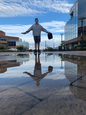 Boy standing at a reflection pool