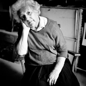 Black and white portrait of artist, hand on chin