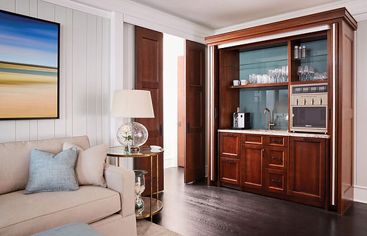 Living room with a unique custom 'barmoire' built from converting an armoire into a wet bar