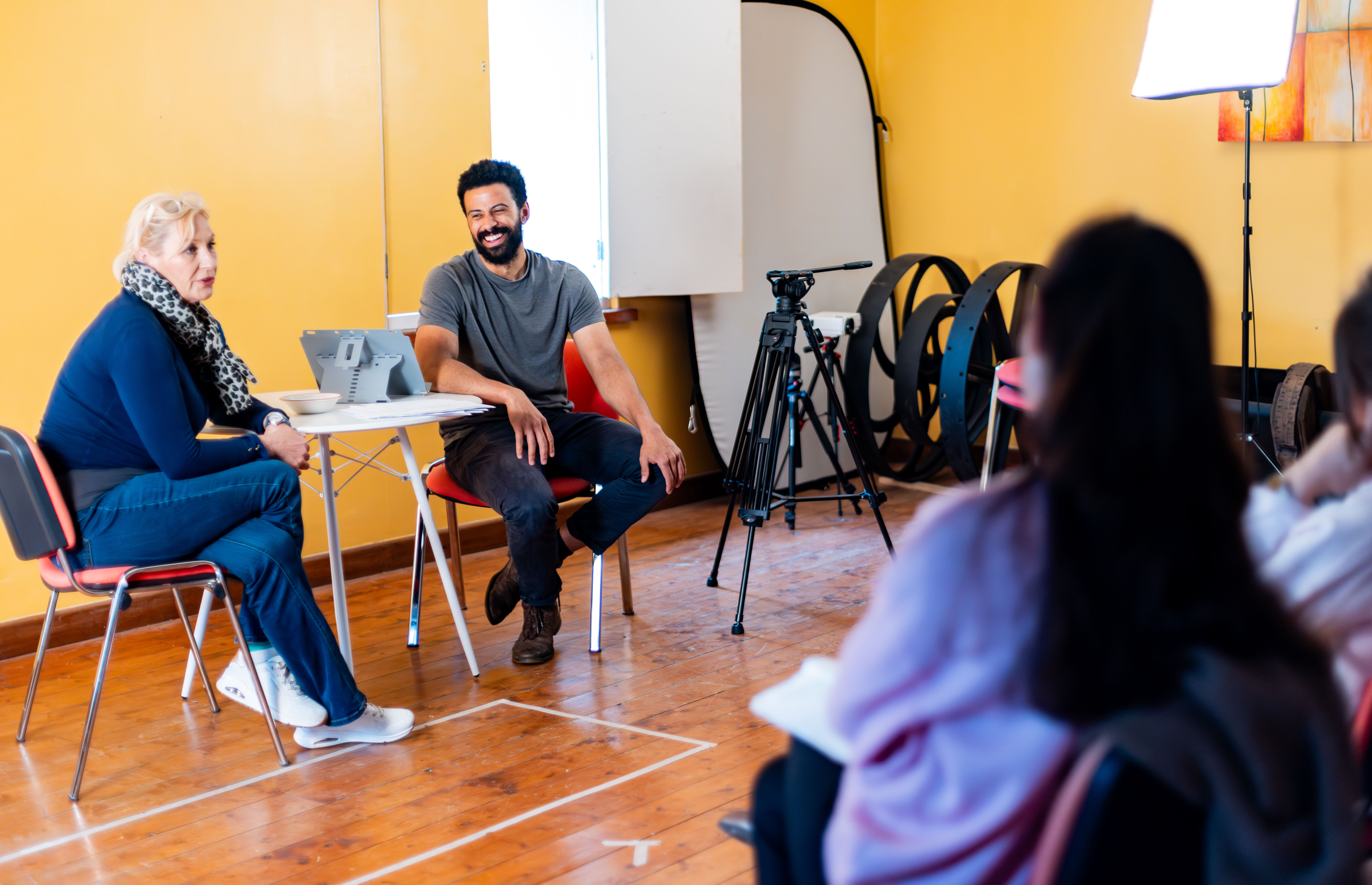 Tutors - Dean Fagan and Ruby Snape teaching an acting class in a room