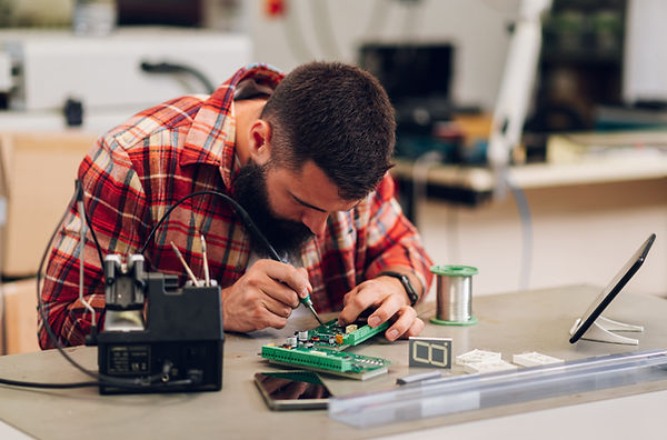 Electronics engineer man repairing computer part in service center. Fixing service in lab.