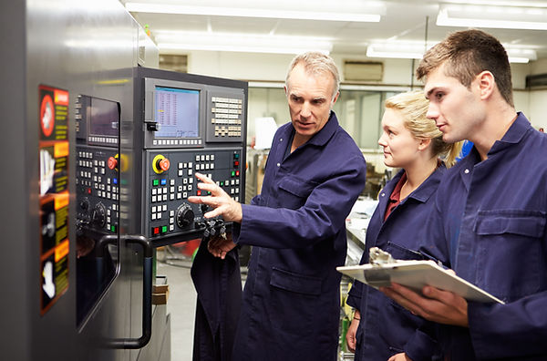 Engineer Teaching Apprentices To Use Computerized Lathe.jpg