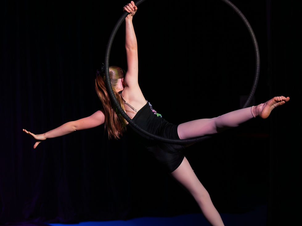 Young circus performer on a lyra aerial hoop