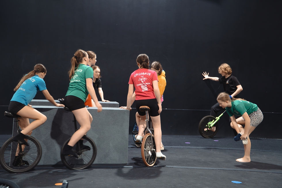Eight students learning unicycle skills and tricks