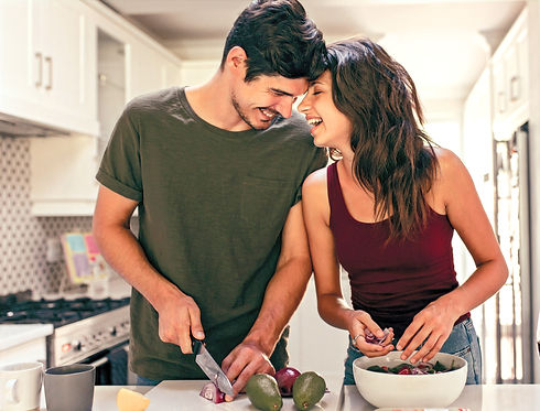 Couple cooking at home laughing after anger management counselling