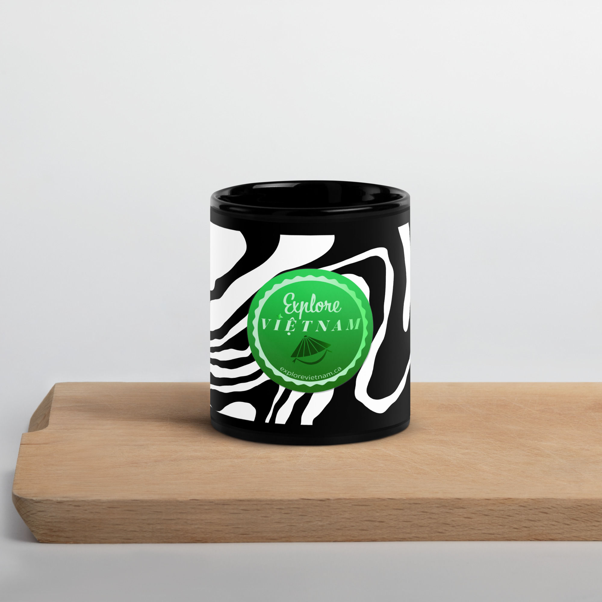 Black Glossy Mug with zebra pattern and Explore Vietnam logo