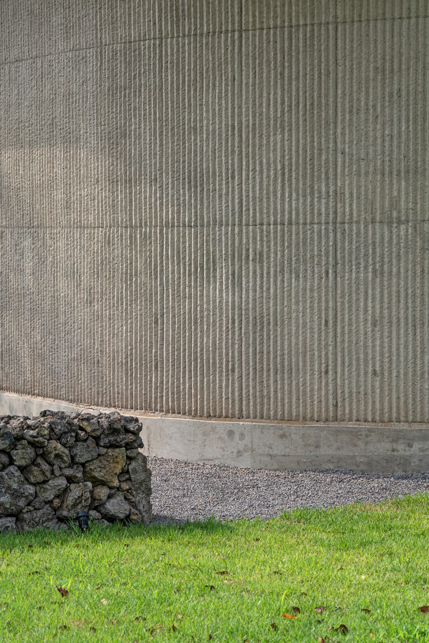 Dwelling in Gotjawal textured concrete facade volcanic stone Kim-O Architects
