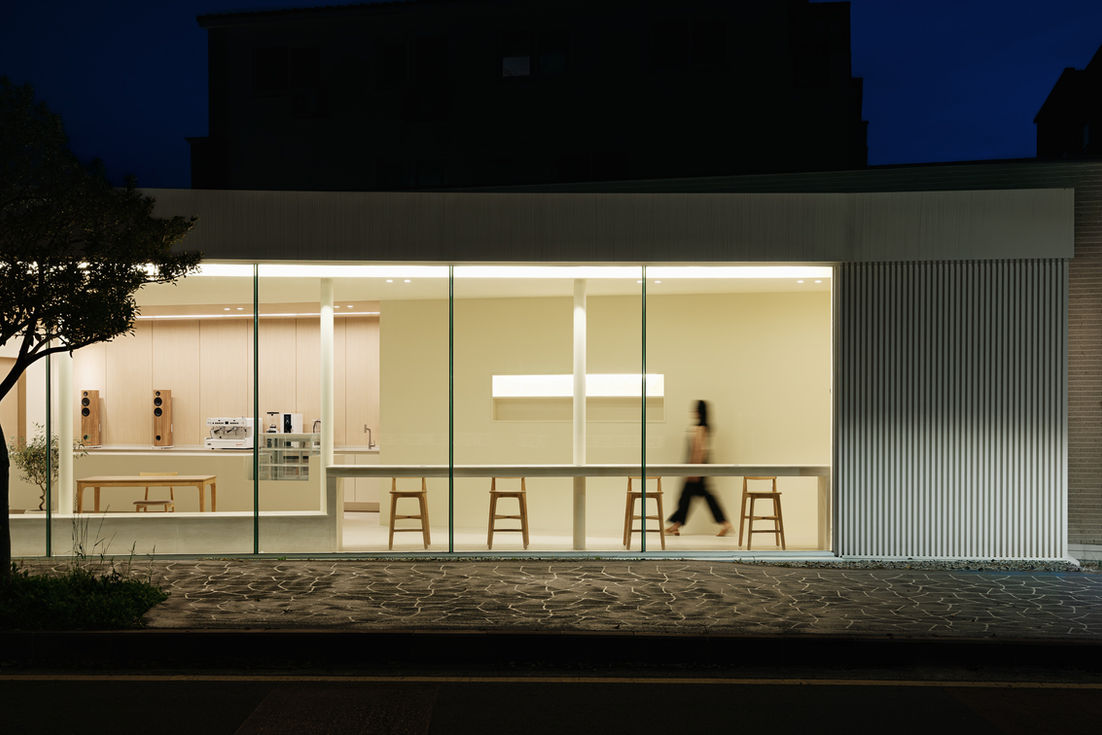 Firefly cafe glass facade night illumination Kim-O Architects