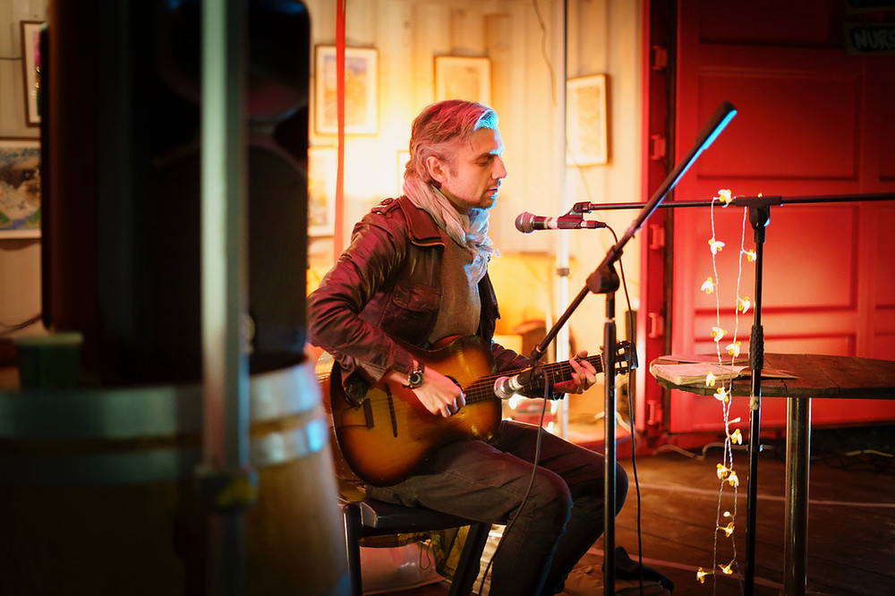 Man playing guitar and singing.