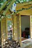 Front of the wooden cabin, wood collected for the fire.