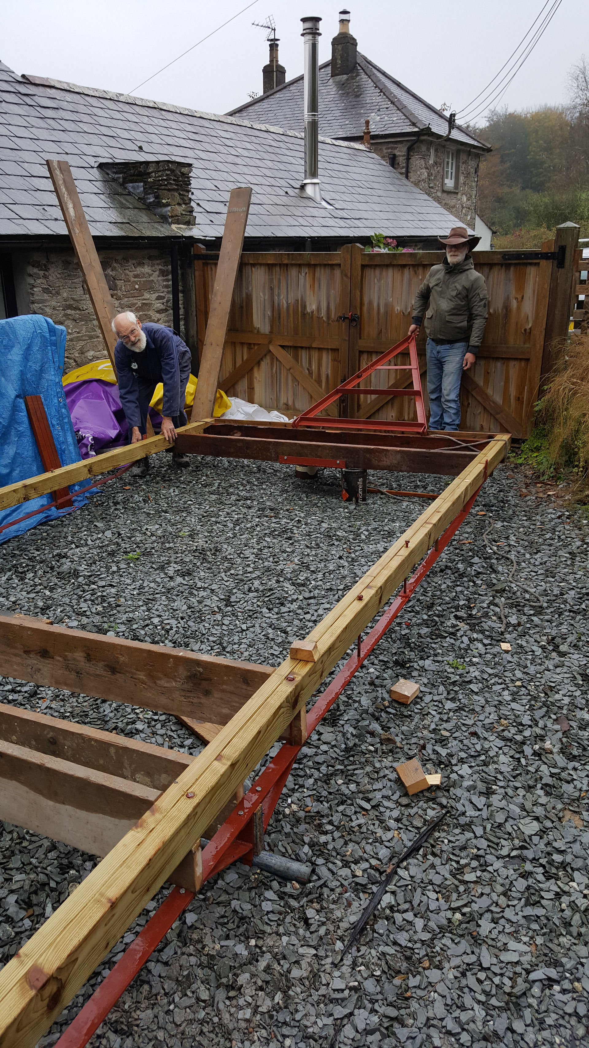 Gary and Alan working with wood and iron to make a large rectangle.
