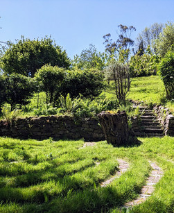 Stone labyrinth in grass, in the sun.