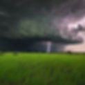 thurndercloud with subtle lightning in the distance rolling in over a texas summers aftern