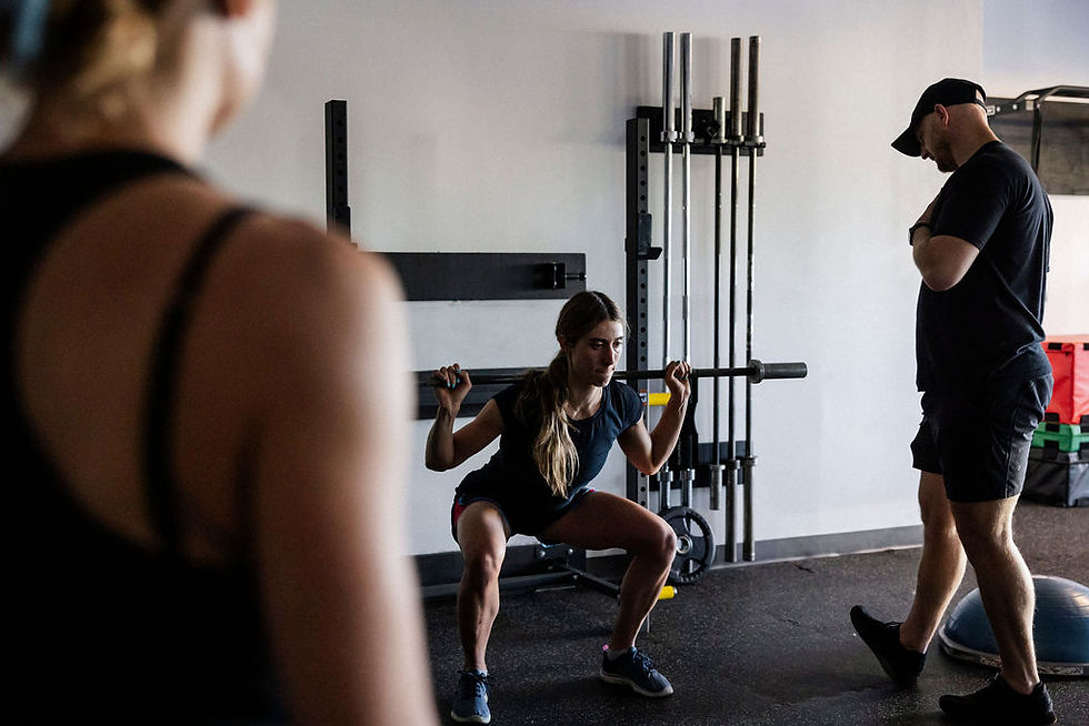 Close-up view of a barbell loaded with weights on a gym floor