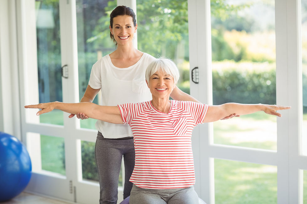 Female coach assisting senior woman in performing exercise