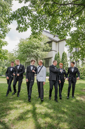 a groom and groomsmen posing for a portrait