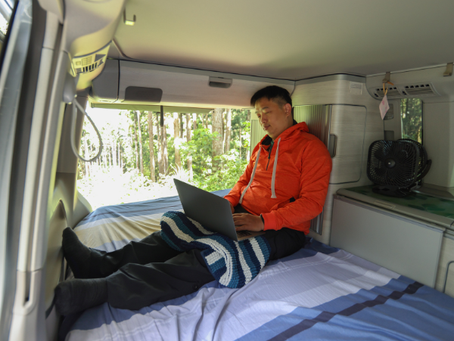guy working on a computer in a van