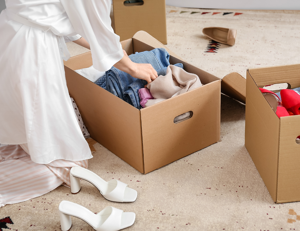 woman decluttering clothing into boxes