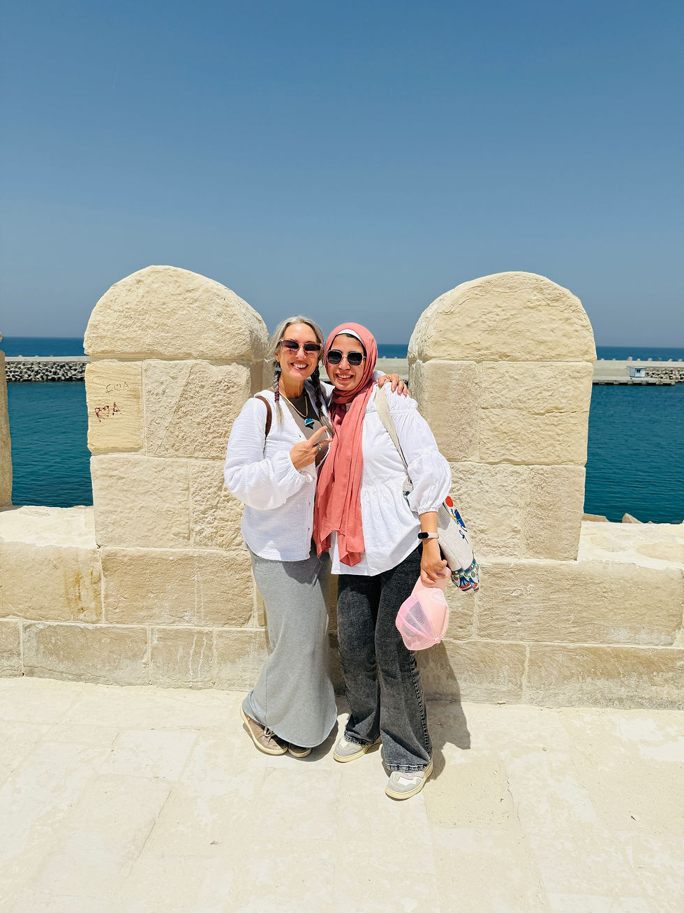 Two females standing near a mosque in Alexandria Egypt
