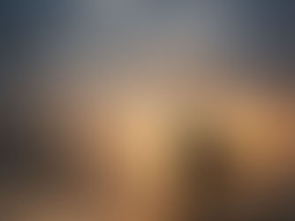 A moody, windswept trail winding through open landscape, with light moving across the path as if the wind itself carries a quiet, unseen voice.