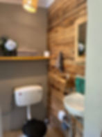 Bathroom in Blackwood Cottage with toilet and basin, wooden wall detail