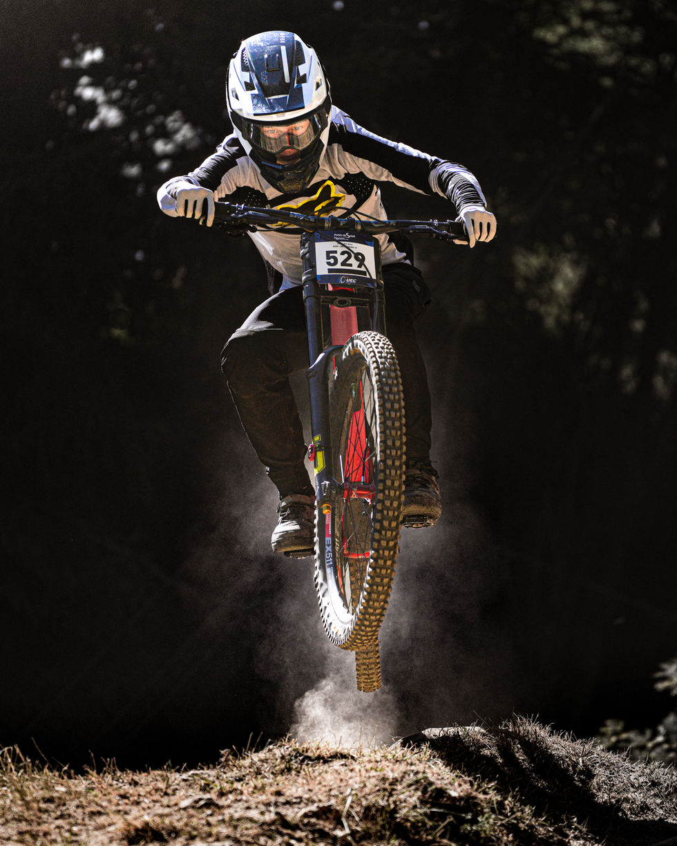 Pilote de VTT en plein saut lors des championnats du monde de Mountain Bike de descente à Champéry, Suisse.