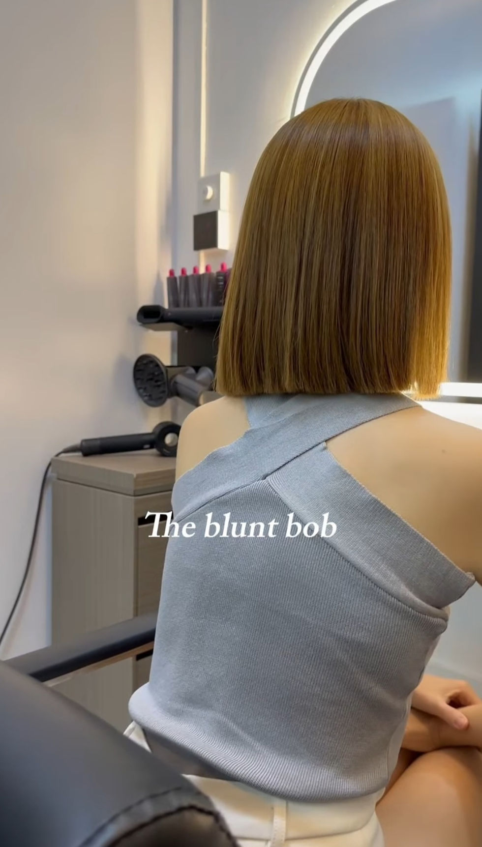 Eye-level view of a sleek Asian bob haircut in a modern salon chair