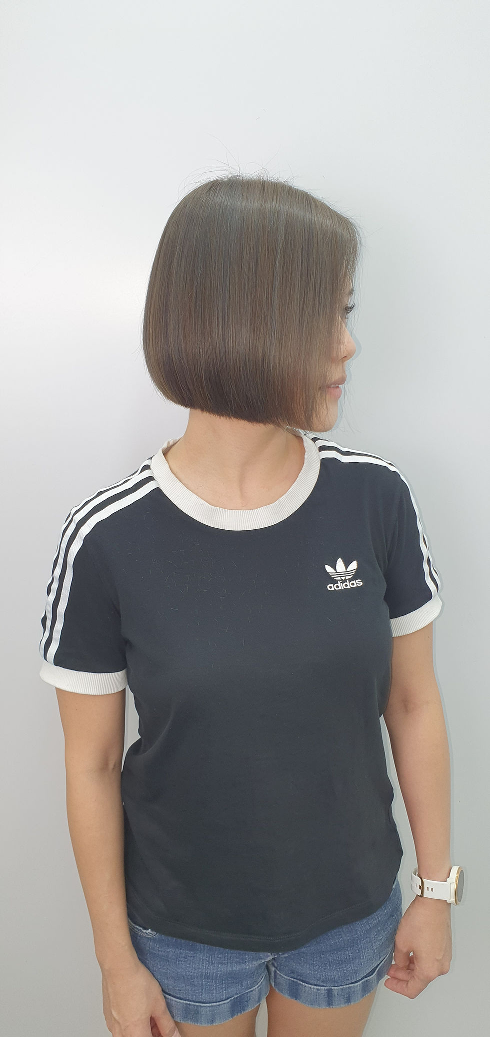 Woman in profile with sleek bob haircut.