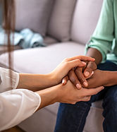 African psychologist hold hands of girl patient, close up. Teenage overcome break up, unre