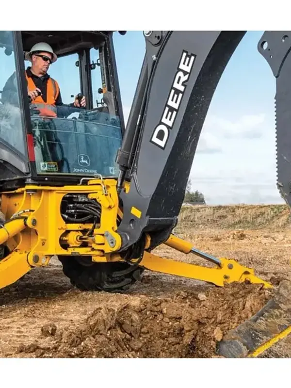 John Deere 310 P-Tier backhoe loader digging at a construction site