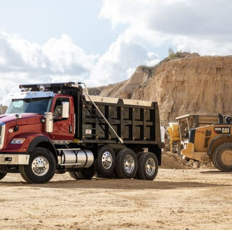 An International HX-series dump truck. The drive-axle tire choice between dual tires and wide-base super singles affects payload capacity, fuel economy, and blowout redundancy. Photo: International Trucks.