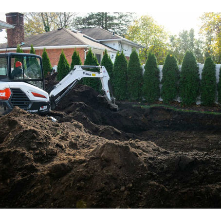 Mini-excavator digging the shell cavity for a residential in-ground swimming pool.