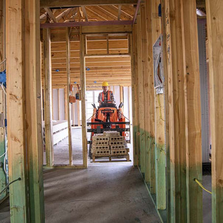 Kubota SCL1000 stand-on compact loader with attachment
