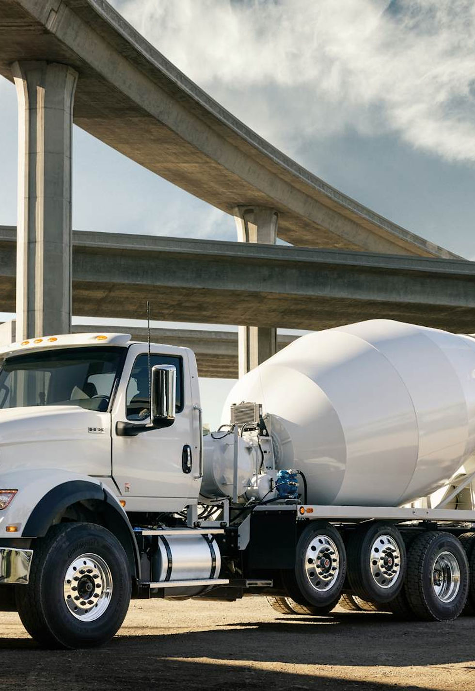 An International HX Series concrete mixer truck. Where the drum is driven and where it's physically supported, front bearing and rear trunnion rollers, are two separate engineering questions on the same machine. Photo: International Trucks.