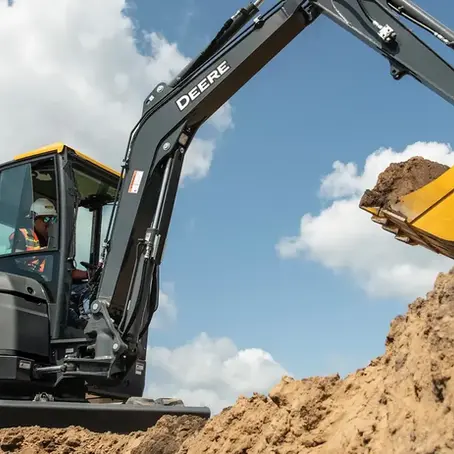 Compact excavator on a Florida jobsite, the kind of growing crew where Florida's E-Verify mandate under SB 1718 applies once an employer passes 25 employees