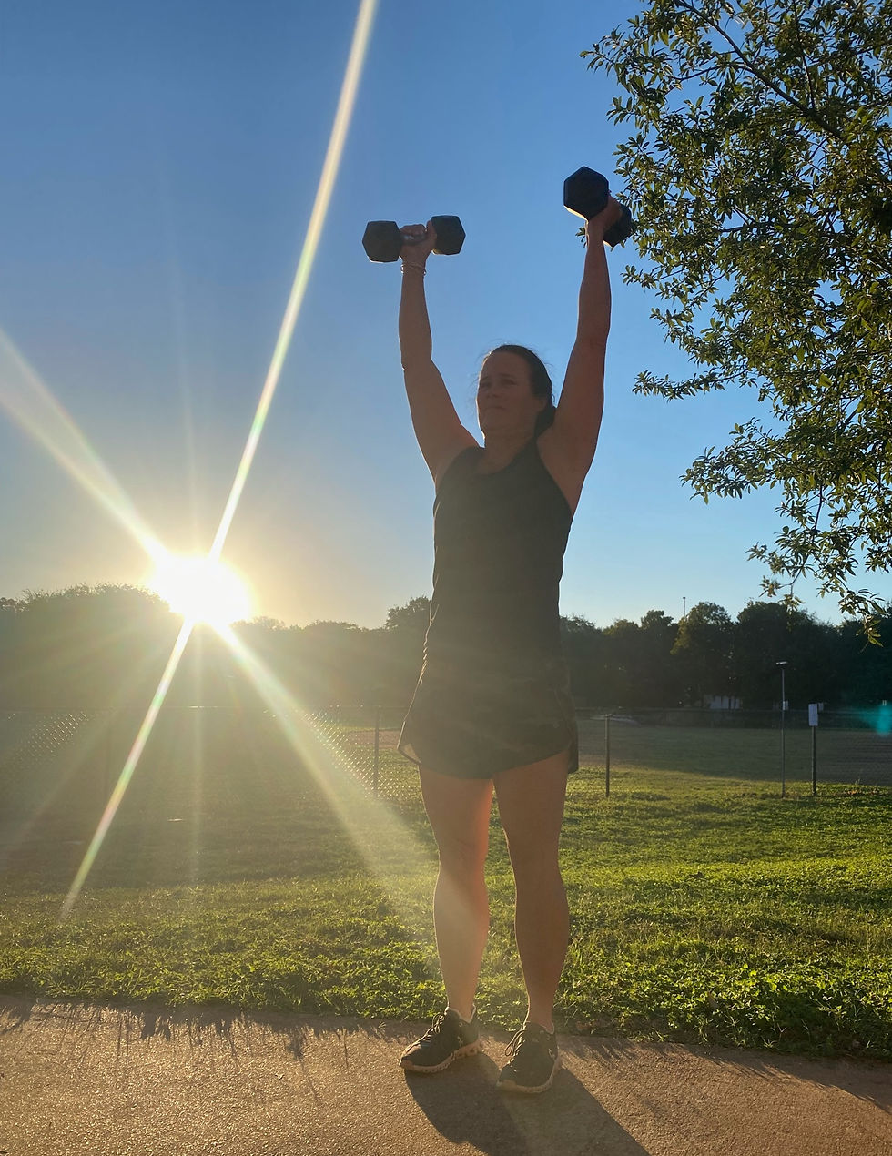 a woman working out outdoors and in the sunlight