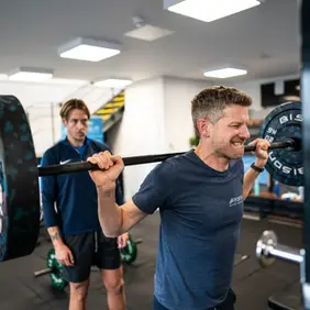 Fit boy lifting weight