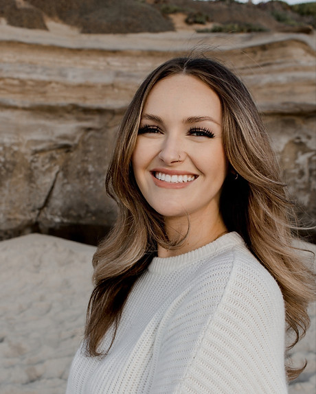 Kami Guevara, therapist, smiling on coast