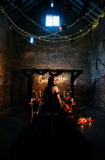 crazy in love neon sign for halloween dark romance wedding featuring the ruby black wedding dress