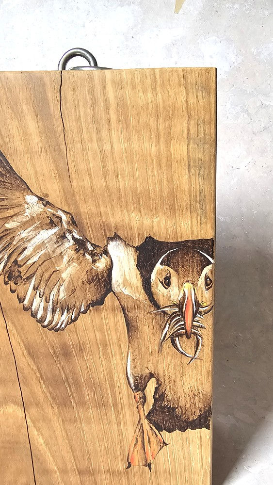 Eye-level view of beautifully grained oak wood planks stacked in a workshop.